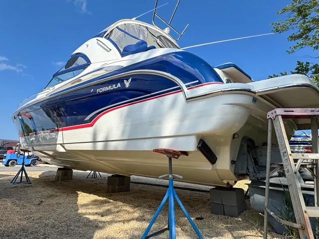 Slide: The Image of 2009 Formula 400ss boat on stands, blue and white design, clear sky background. - 7