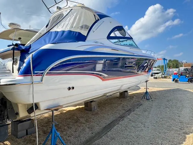 Slide: The Image of 2009 Formula 400ss boat on stands, blue and white design, clear sky background. - 8