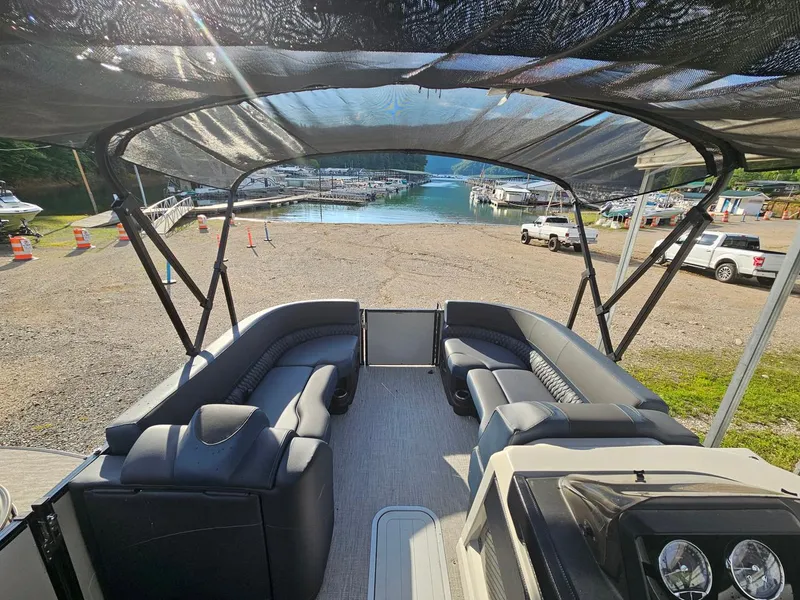 Slide: The Image of 2025 Tahoe Pontoon Cascade Cruise Rear Bench at a lakeside dock. - 4