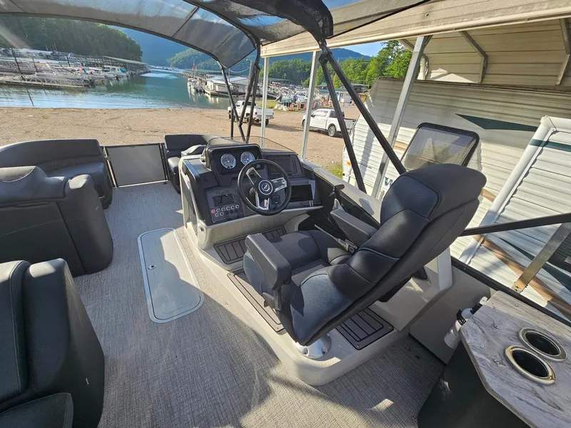 Slide: The Image of 2025 Tahoe Pontoon Cascade Cruise Rear Bench interior with steering console and seating. - 6