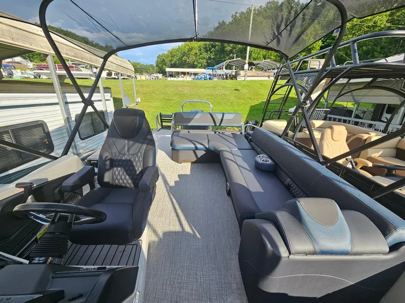 Slide: The Image of 2025 Tahoe Pontoon Cascade Cruise Rear Bench interior with seating and steering wheel. - 8