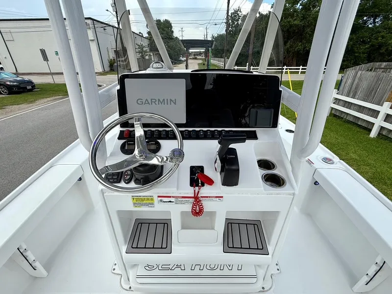Slide: The Image of 2023 Sea Hunt BX22 boat console with Garmin display and steering wheel. - 11