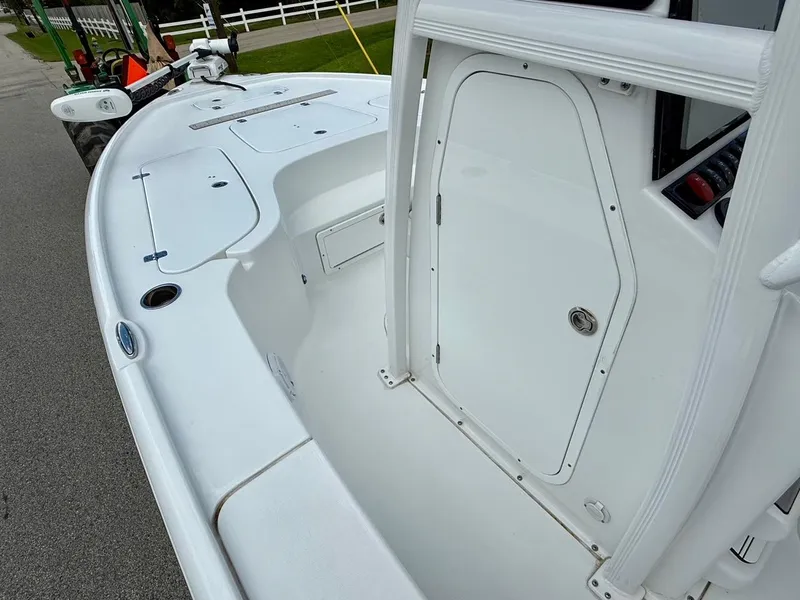 Slide: The Image of 2023 Sea Hunt BX22 boat interior with storage compartments and control panel. - 13