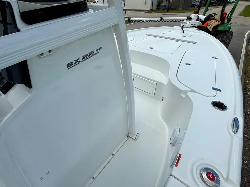 Slide: The Image of 2023 Sea Hunt BX22 boat interior with sleek white design and modern features. - 16