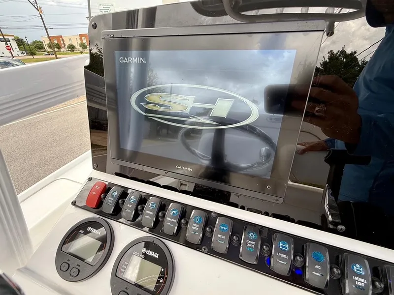Slide: The Image of 2023 Sea Hunt BX22 boat dashboard with Garmin display and Yamaha controls. - 17