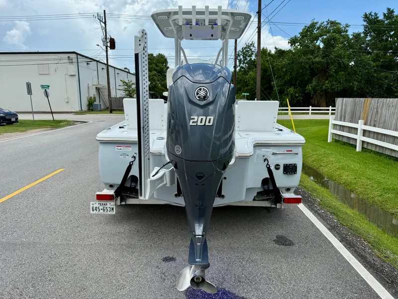 Slide: The Image of 2023 Sea Hunt BX22 boat with Yamaha 200 engine on a street. - 3