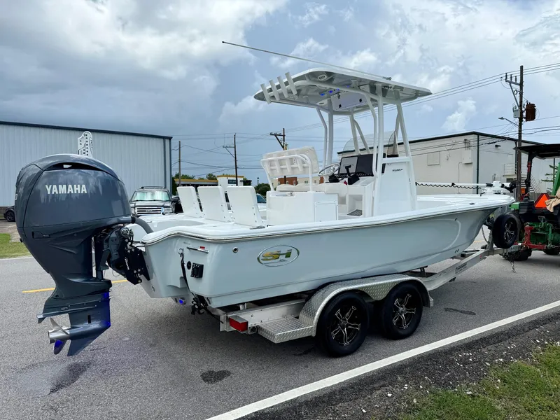 Slide: The Image of 2023 Sea Hunt BX22 boat on trailer with Yamaha outboard motor, parked outdoors. - 4