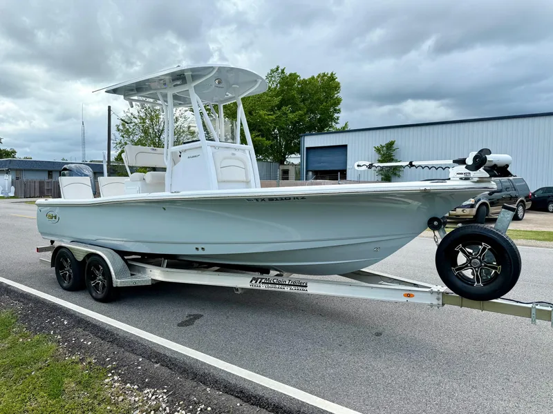 Slide: The Image of 2023 Sea Hunt BX22 boat on trailer, parked on roadside under cloudy sky. - 5