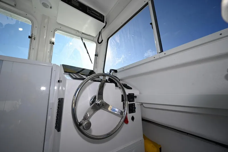 Slide: The Image of Interior view of 2026 Steiger Craft 255 Miami boat cockpit with steering wheel. - 11