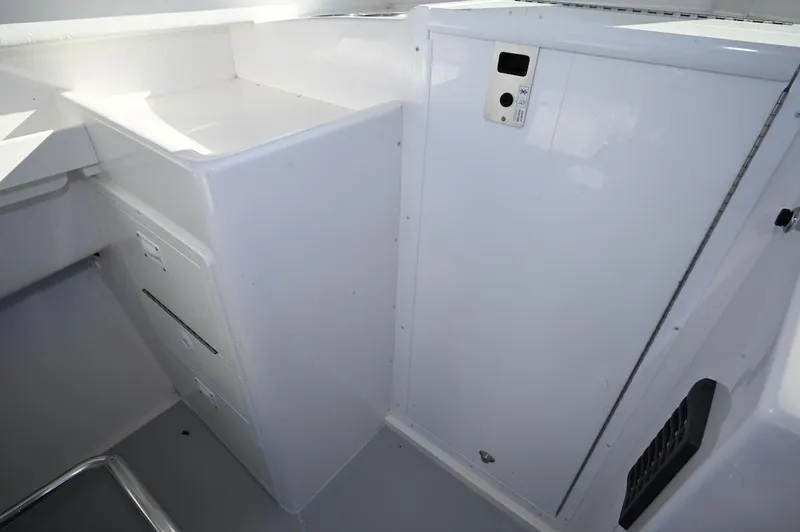 Slide: The Image of Interior view of 2026 Steiger Craft 255 Miami boat, featuring storage compartments. - 9