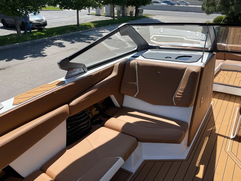 Slide: The Image of 2025 Nautique Super Air Nautique G25 interior with tan leather seating and sleek design. - 10