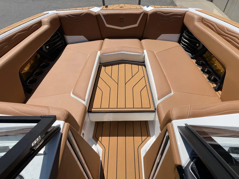 Slide: The Image of Luxurious interior of 2025 Nautique Super Air Nautique G25 boat with tan seating. - 11