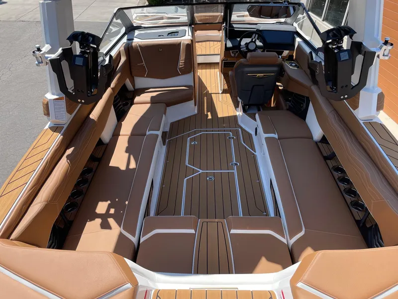 Slide: The Image of 2025 Nautique Super Air Nautique G25 interior with brown seating and sleek design. - 5