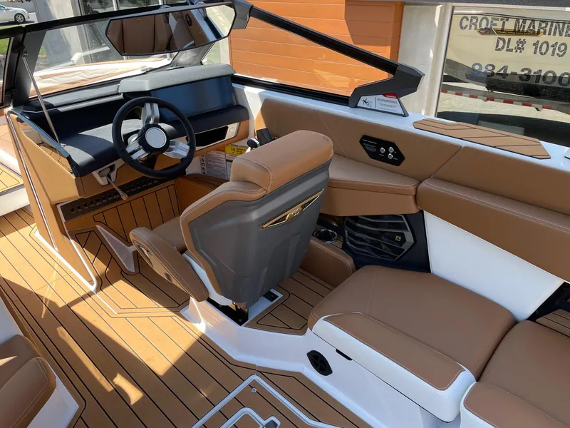 Slide: The Image of 2025 Nautique Super Air Nautique G25 interior with tan seating and modern dashboard design. - 6