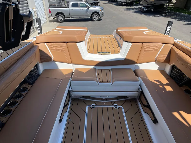Slide: The Image of 2025 Nautique Super Air Nautique G25 interior with tan leather seating and sleek design. - 8