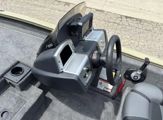 Slide: The Image of 2025 Tracker Pro Team 175 boat dashboard with steering wheel and control panel. - 14