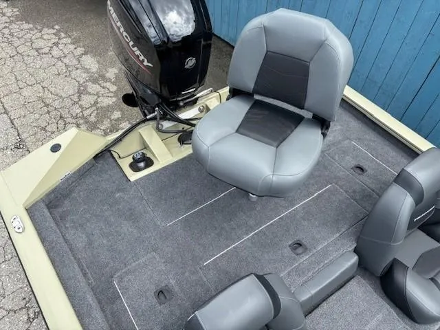 Slide: The Image of 2025 Tracker Pro Team 175 boat interior with gray seating and Mercury outboard motor. - 19