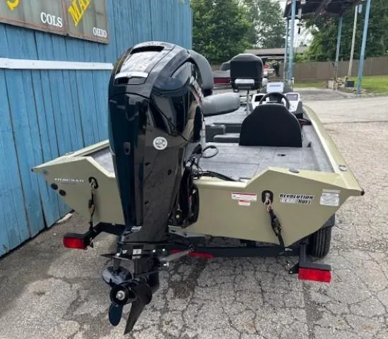 Slide: The Image of 2025 Tracker Pro Team 175 boat with outboard motor, parked on a concrete surface. - 3