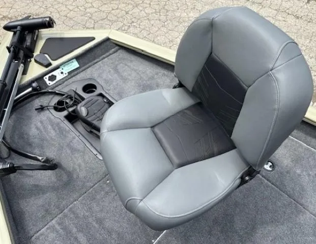 Slide: The Image of 2025 Tracker Pro Team 175 boat seat with control panel and cup holders. - 9