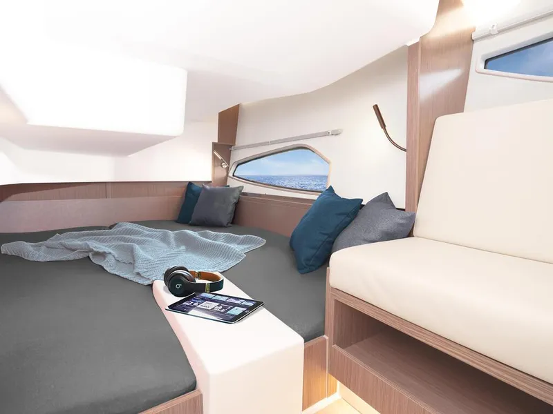 Slide: The Image of 2024 Sealine C335V yacht interior with cozy bed, pillows, and tablet. - 16