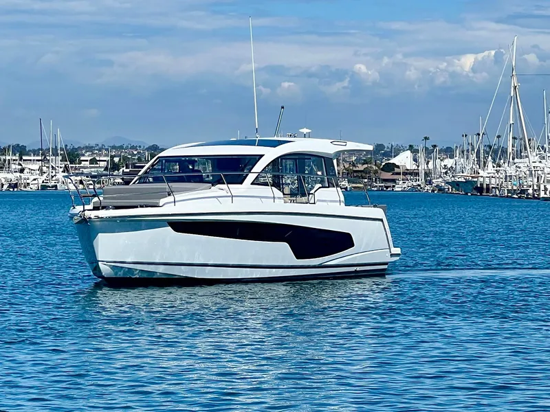 Slide: The Image of 2024 Sealine C335V yacht cruising in a marina under a clear blue sky. - 2