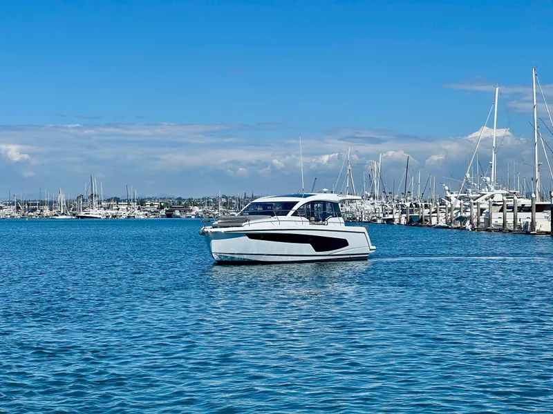 Slide: The Image of 2024 Sealine C335V yacht cruising in a marina under a clear blue sky. - 3