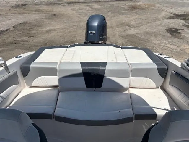 Slide: The Image of 2019 Chaparral 210 Deluxe boat interior with seating and outboard motor. - 11