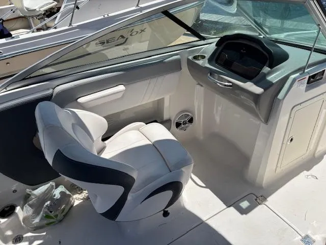 Slide: The Image of 2019 Chaparral 210 Deluxe boat interior with captain's chair and dashboard. - 13
