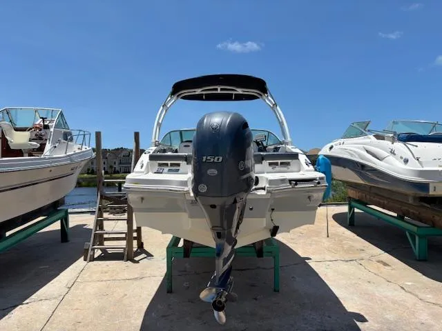 Slide: The Image of 2019 Chaparral 210 Deluxe boat with outboard motor on dry dock. - 6