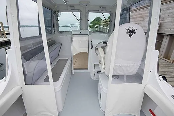 Slide: The Image of 2026 Steiger Craft 23 Miami boat interior with seating and steering wheel. - 12