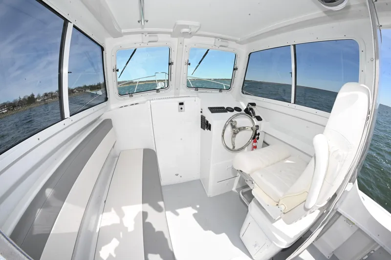 Slide: The Image of Interior of 2026 Steiger Craft 23 Miami boat, featuring helm and seating with ocean view. - 14