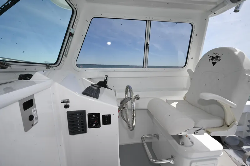 Slide: The Image of Steiger Craft 23 Miami 2026 boat interior with steering wheel and captain's chair. - 15