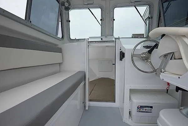 Slide: The Image of 2026 Steiger Craft 23 Miami boat interior with seating and steering wheel. - 16