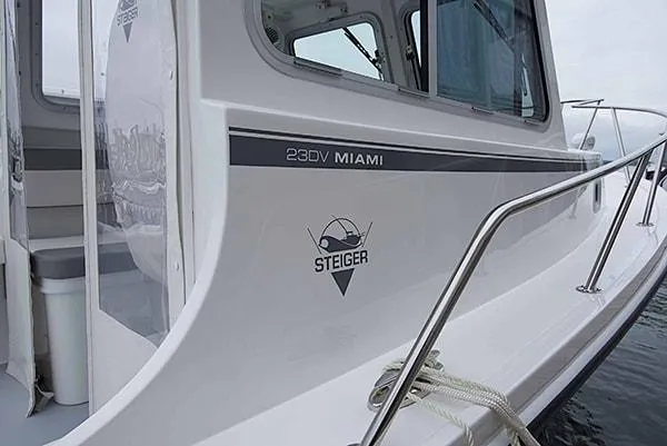 Slide: The Image of 2026 Steiger Craft 23 Miami boat, sleek design, white exterior, docked with visible logo and railing. - 19