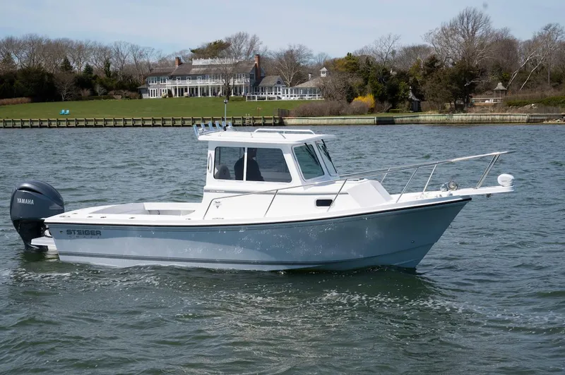 Slide: The Image of 2026 Steiger Craft 23 Miami boat on water, with Yamaha engine, near waterfront property. - 3