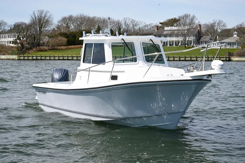 Slide: The Image of 2026 Steiger Craft 23 Miami boat cruising on a scenic waterway. - 4