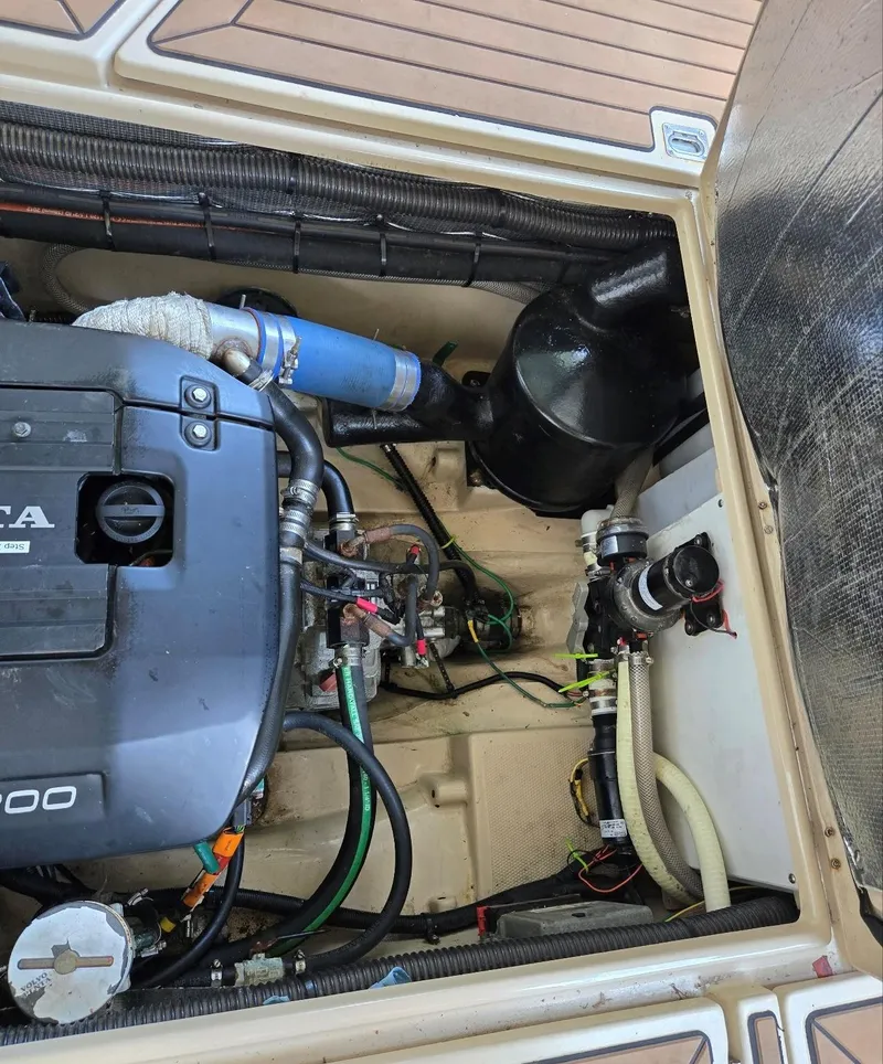 Slide: The Image of Engine compartment of a 2014 Ranger Tugs R-27 boat, showcasing mechanical components. - 18