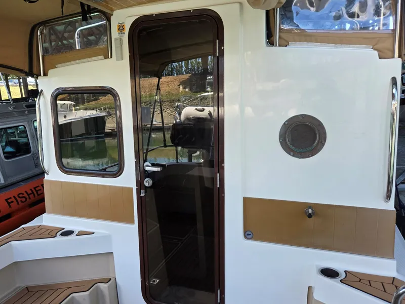 Slide: The Image of 2014 Ranger Tugs R-27 boat exterior with door and windows. - 21