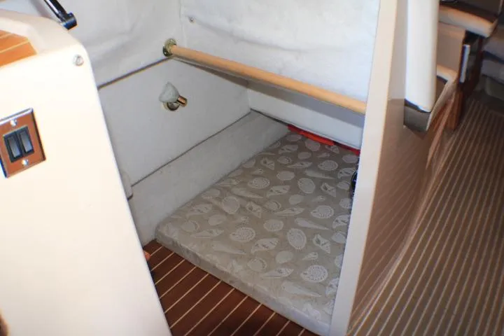 Slide: The Image of 2014 Ranger Tugs R-27 interior cabin with patterned mattress and wooden flooring. - 46