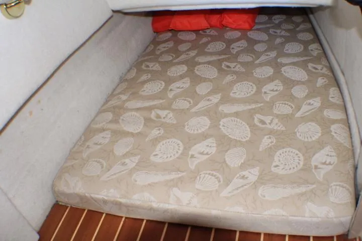 Slide: The Image of 2014 Ranger Tugs R-27 cabin with seashell-patterned mattress and wooden flooring. - 47
