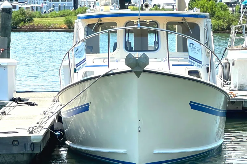 Slide: The Image of Rosborough 246LVS boat from 2000 on calm blue waters under clear sky. - 1