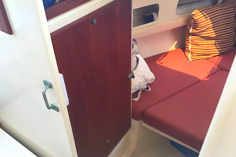 Slide: The Image of Interior of 2000 Rosborough 246LVS boat featuring a compact kitchen area with sink and cabinets. - 10