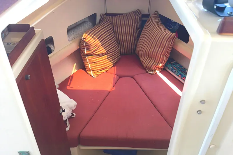 Slide: The Image of Interior of 2000 Rosborough 246LVS boat with red cushions and wooden cabinet. - 11
