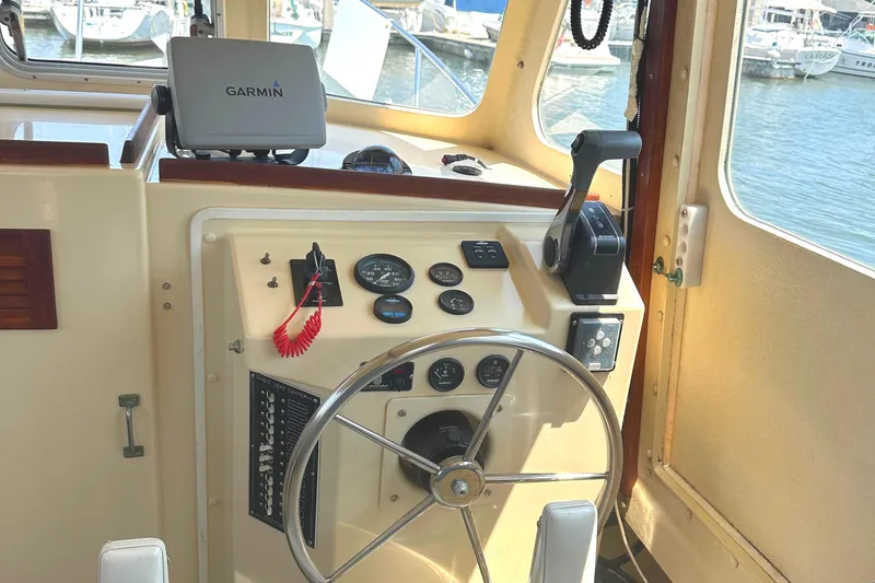 Slide: The Image of Rosborough 246LVS 2000 boat helm with Garmin GPS, steering wheel, and control panel. - 13