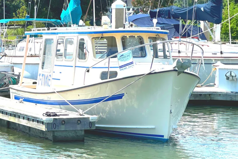 Slide: The Image of 2000 Rosborough 246LVS boat docked at marina, featuring covered outboard motor. - 18