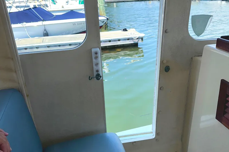 Slide: The Image of Rosborough 246LVS 2000 boat interior with storage hatch and coiled rope. - 19