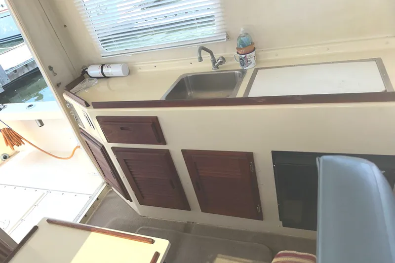 Slide: The Image of A 2000 Rosborough 246LVS boat on calm blue waters with distant shoreline. - 2