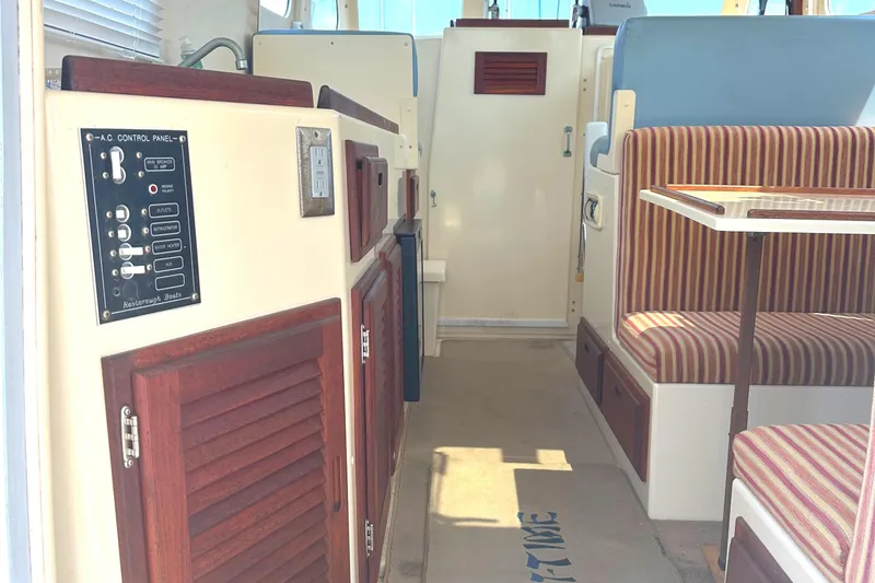 Slide: The Image of Cozy cabin interior of 2000 Rosborough 246LVS boat with red cushions and striped pillows. - 25