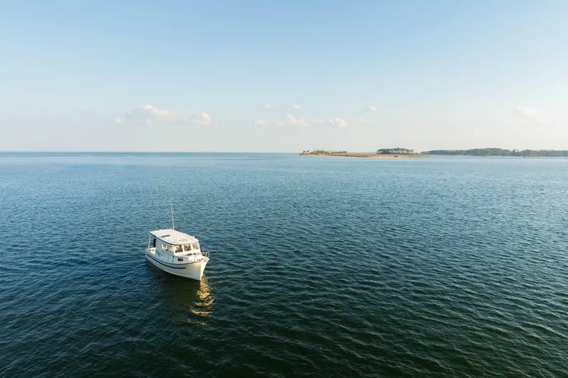 Slide: The Image of Interior of 2000 Rosborough 246LVS boat with kitchenette, seating, and helm station. - 30