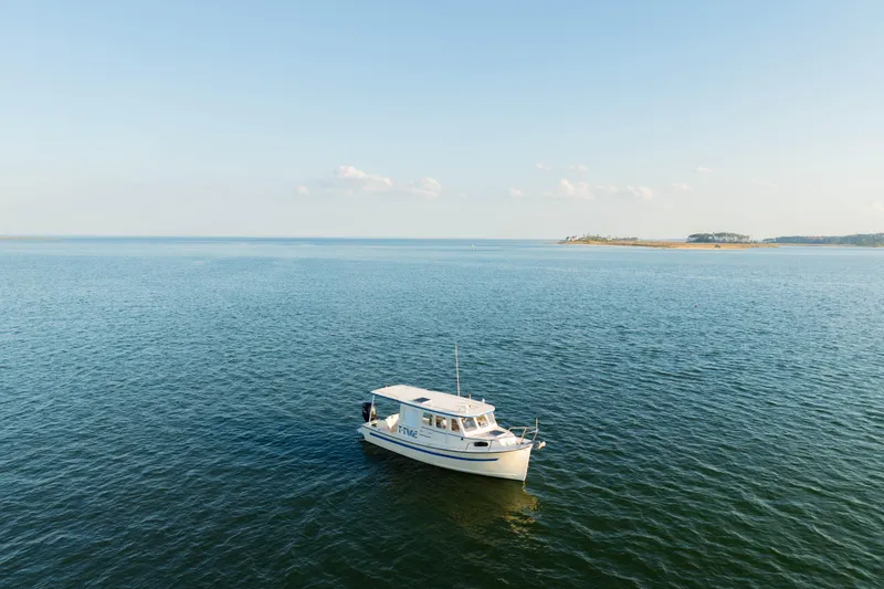 Slide: The Image of Interior of 2000 Rosborough 246LVS boat with red cushions and wooden cabinet. - 31
